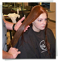 client at a hair extension maintenance appointment