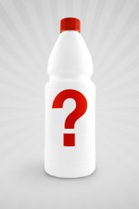 Unlabeled plastic Bottle for chemical liquid with question mark on gray background representing chemicals damaging hair