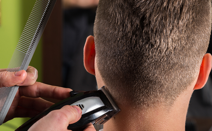 clippers cutting mans hair closeup