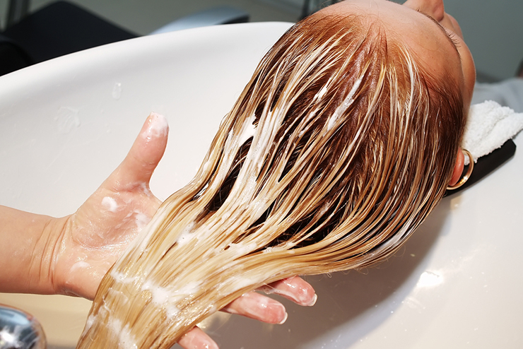 stylist washing client hair