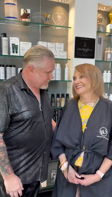 Salon Owner David Barron smiling with a happy client.