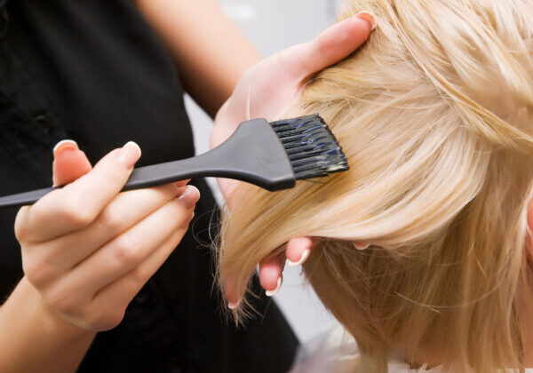 Hair coloring in a beauty salon in blonde. Hairdressing services.